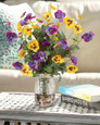 Pansy Perfect Faux Flower Arrangement arranged with pebbles in a pint mason jar of clear acrylic water. Available at Petals.