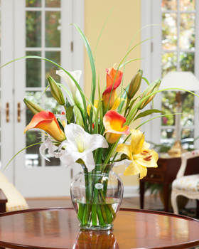 Bright silk calla lily, day lily, silk flower accent and artificial grasses set in acrylic water in 7" glass vase